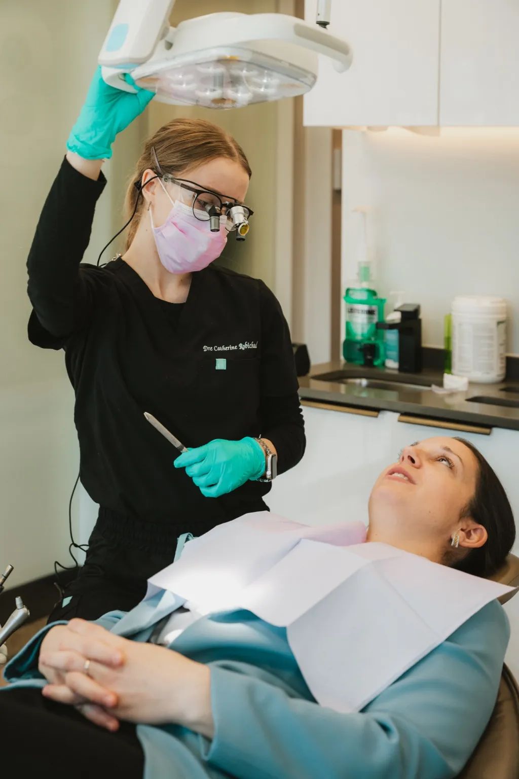 Dentiste préparant une patiente avant un examen dans une salle de soins dentaire